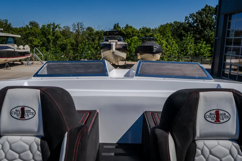 Slide: The Image of 2023 Cigarette 515 boat interior with branded seats and outdoor marina view. - 36
