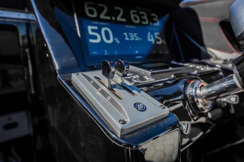 Slide: The Image of Control panel of 2023 Cigarette 515 boat with digital display and throttle levers. - 55