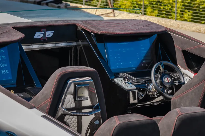 Slide: The Image of 2023 Cigarette 515 boat interior with advanced dashboard and steering wheel. - 69