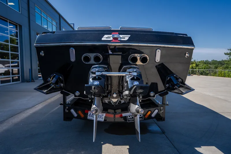 Slide: The Image of Rear view of 2023 Cigarette 515 boat with dual propellers and sleek black design. - 24