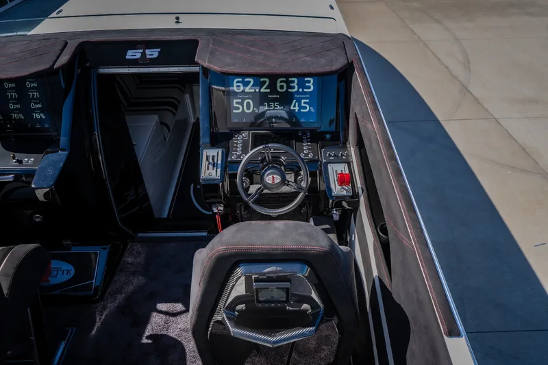 Slide: The Image of Cockpit of 2023 Cigarette 515 boat with advanced digital displays and steering wheel. - 47
