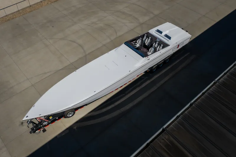Slide: The Image of Aerial view of 2023 Cigarette 515 speedboat on trailer, parked on concrete surface. - 16
