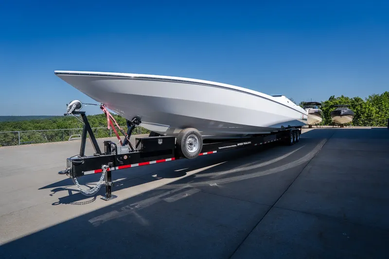 Slide: The Image of 2023 Cigarette 515 boat on trailer under clear blue sky. - 7