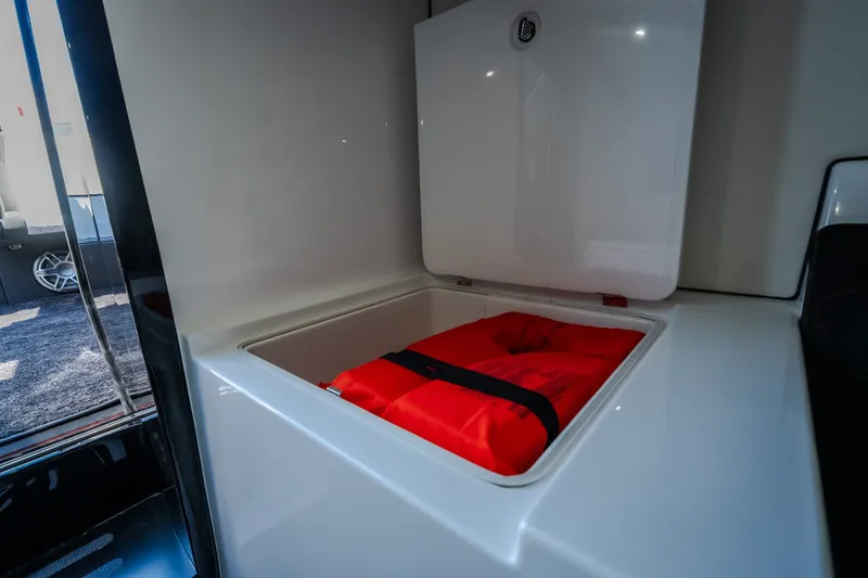 Slide: The Image of 2023 Cigarette 515 storage compartment with red life jacket inside. - 79
