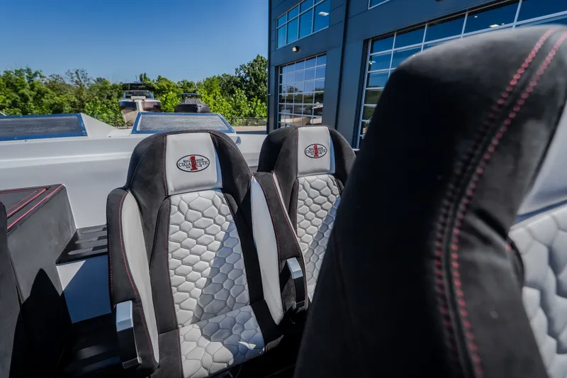 Slide: The Image of 2023 Cigarette 515 boat seats with hexagonal pattern and logo, outdoors. - 57