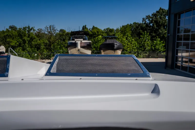 Slide: The Image of 2023 Cigarette 515 boat detail with mesh panel, docked near other boats. - 35