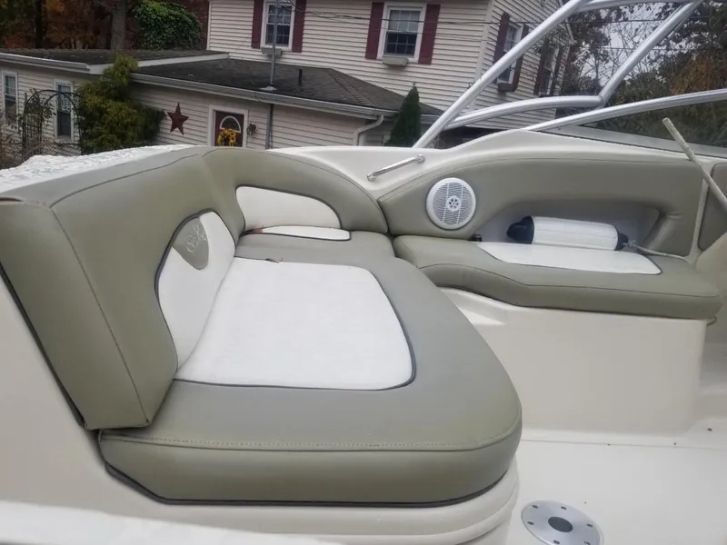 Slide: The Image of 2006 Sea Ray 270 Sundeck interior with beige and white seating, outdoor setting. - 12