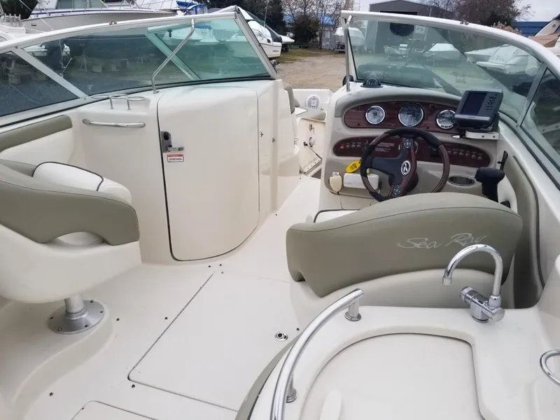 Slide: The Image of 2006 Sea Ray 270 Sundeck interior with steering wheel and seating area. - 18