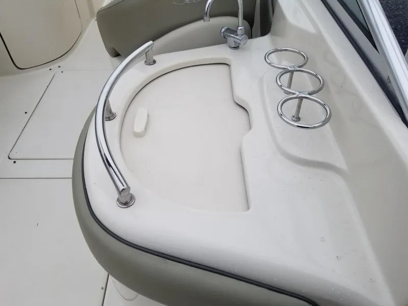 Slide: The Image of 2006 Sea Ray 270 Sundeck boat sink with cup holders and railing. - 19
