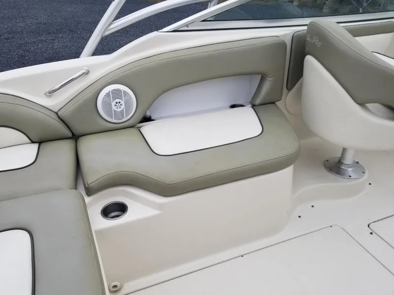 Slide: The Image of 2006 Sea Ray 270 Sundeck interior with cushioned seating and built-in speaker. - 20