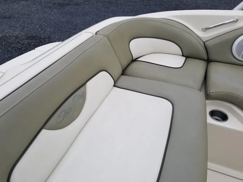 Slide: The Image of 2006 Sea Ray 270 Sundeck boat interior with beige and white cushioned seating. - 21