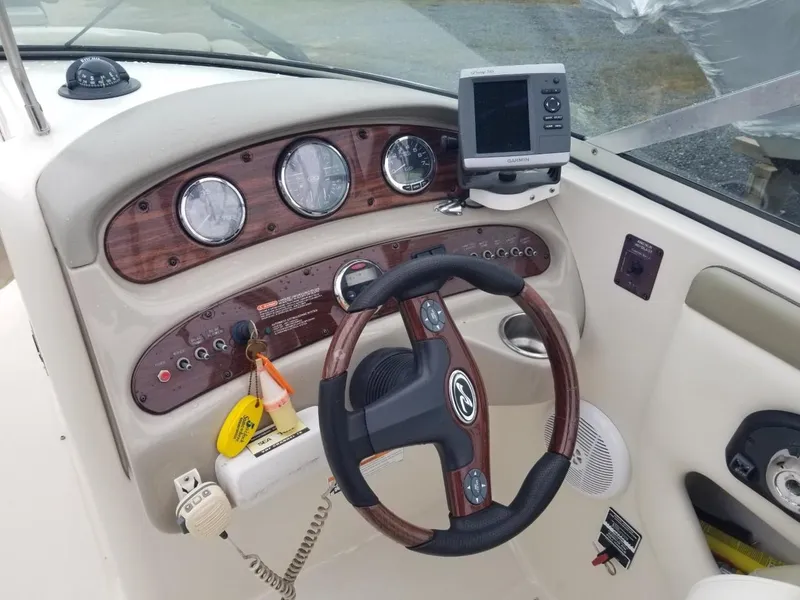 Slide: The Image of 2006 Sea Ray 270 Sundeck dashboard with steering wheel and navigation instruments. - 23