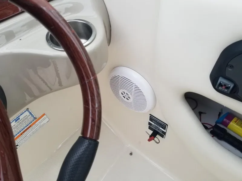 Slide: The Image of Steering wheel and speaker on 2006 Sea Ray 270 Sundeck boat interior. - 25