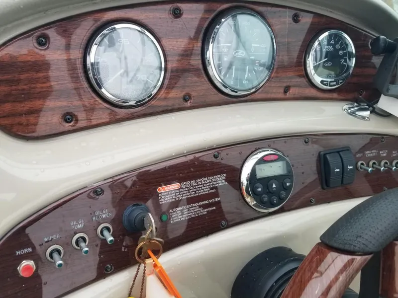 Slide: The Image of Dashboard of a 2006 Sea Ray 270 Sundeck boat with gauges and controls. - 26