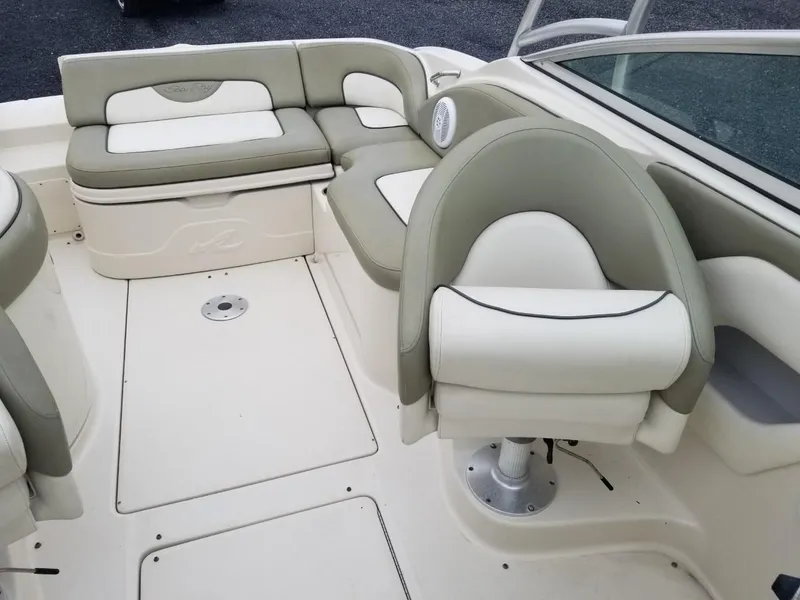 Slide: The Image of 2006 Sea Ray 270 Sundeck interior with white and gray seating arrangement. - 31