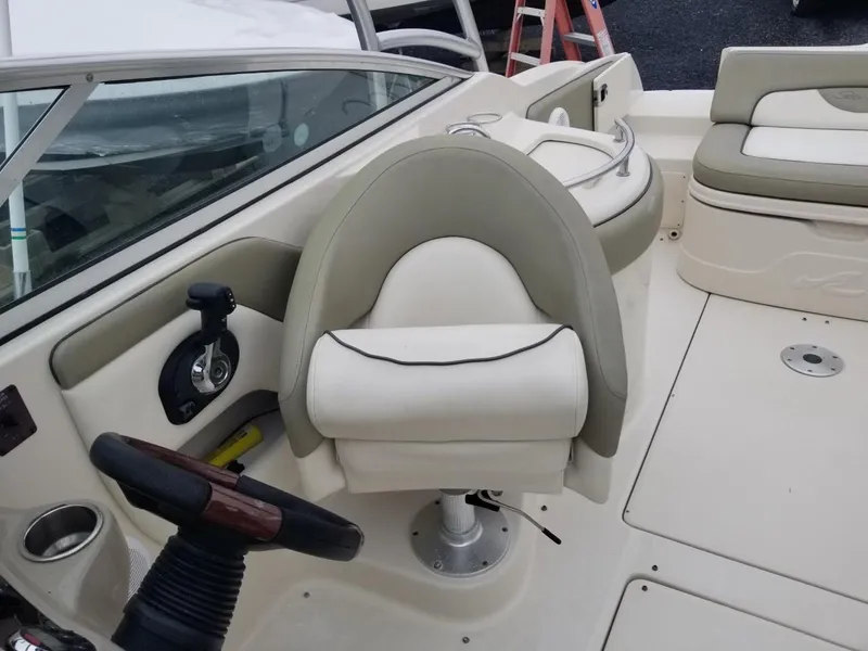 Slide: The Image of 2006 Sea Ray 270 Sundeck boat interior with helm and seating area. - 32