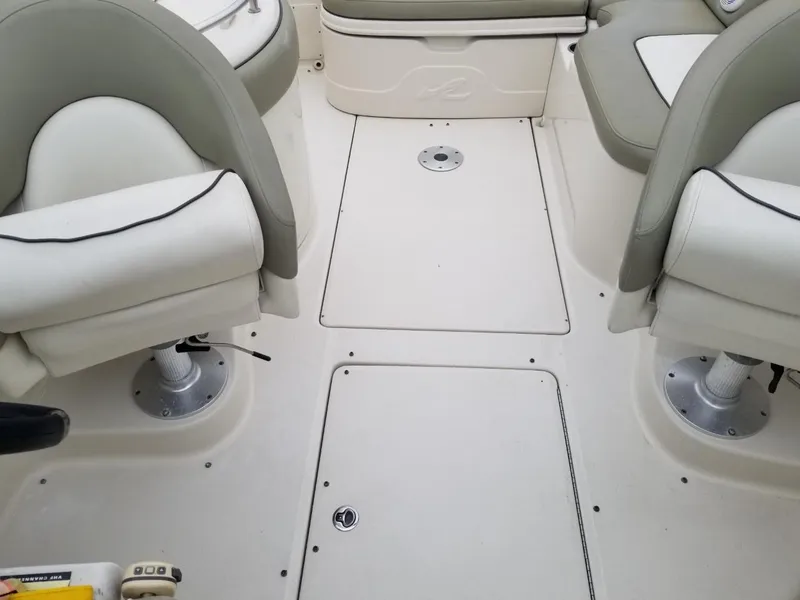 Slide: The Image of 2006 Sea Ray 270 Sundeck interior with white seating and deck layout. - 33