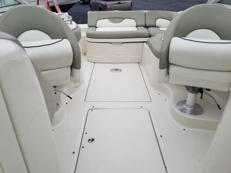 Slide: The Image of 2006 Sea Ray 270 Sundeck interior with white seating and spacious deck layout. - 38