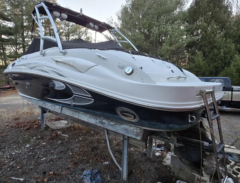 Slide: The Image of 2006 Sea Ray 270 Sundeck boat on a stand, surrounded by trees. - 4