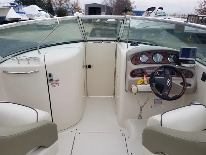 Slide: The Image of 2006 Sea Ray 270 Sundeck boat interior with steering wheel and dashboard controls. - 40