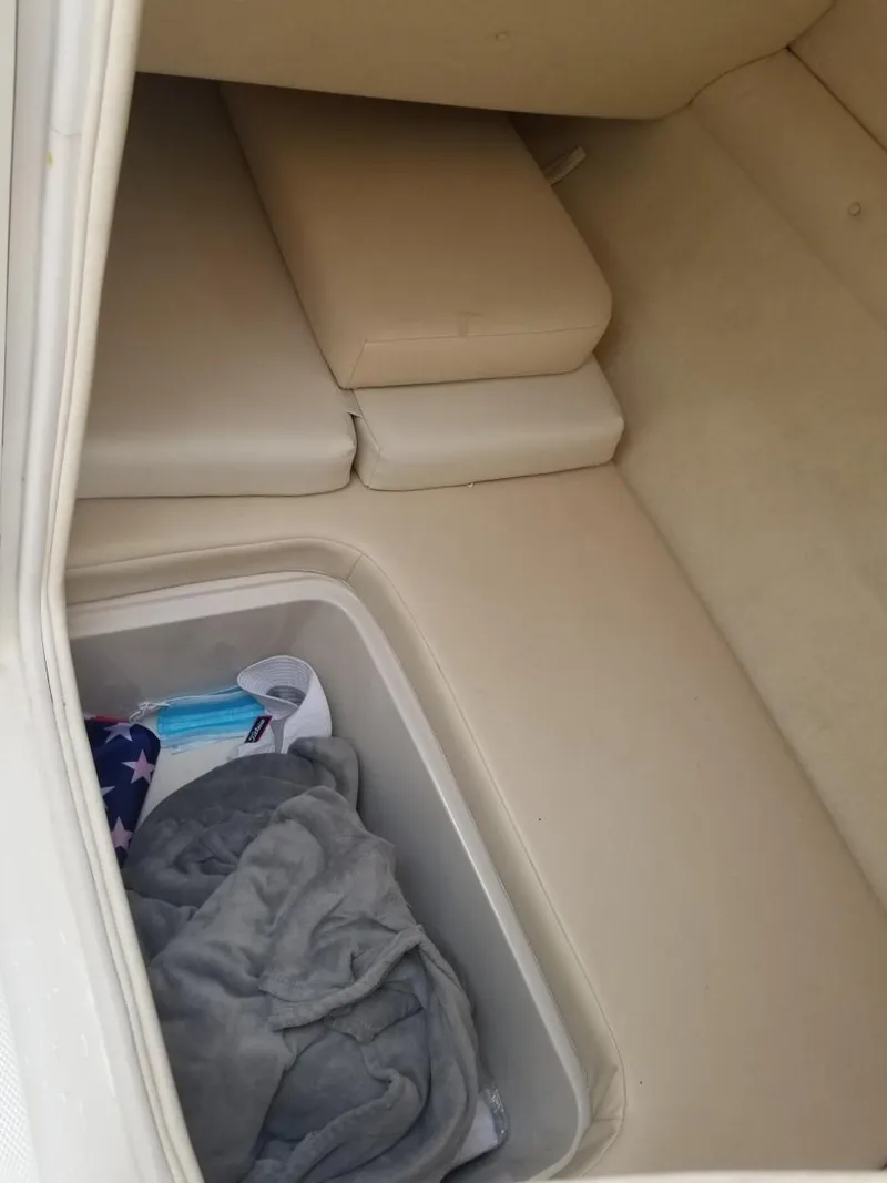 Slide: The Image of 2006 Sea Ray 270 Sundeck interior storage compartment with cushions and blanket. - 43