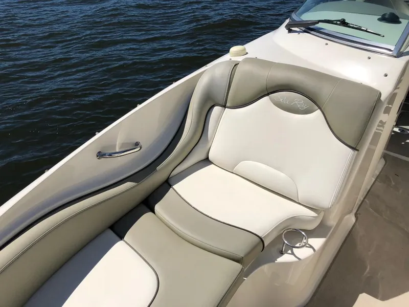 Slide: The Image of 2006 Sea Ray 270 Sundeck boat with beige seating, on calm water. - 47