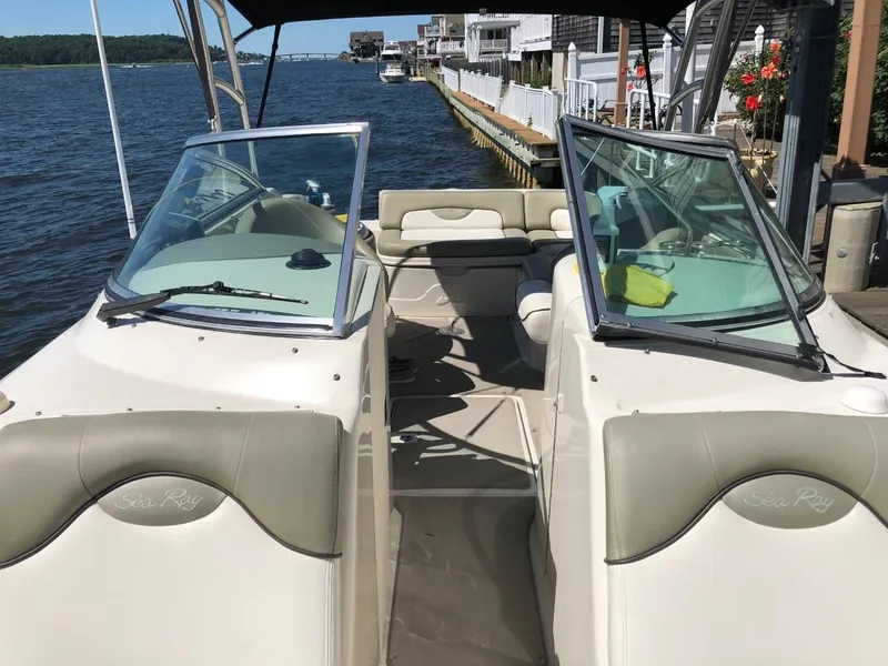 Slide: The Image of 2006 Sea Ray 270 Sundeck boat docked by waterfront homes. - 49