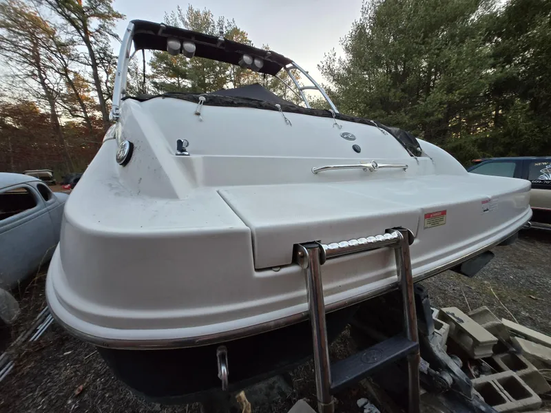 Slide: The Image of 2006 Sea Ray 270 Sundeck boat, rear view with ladder, parked outdoors. - 5