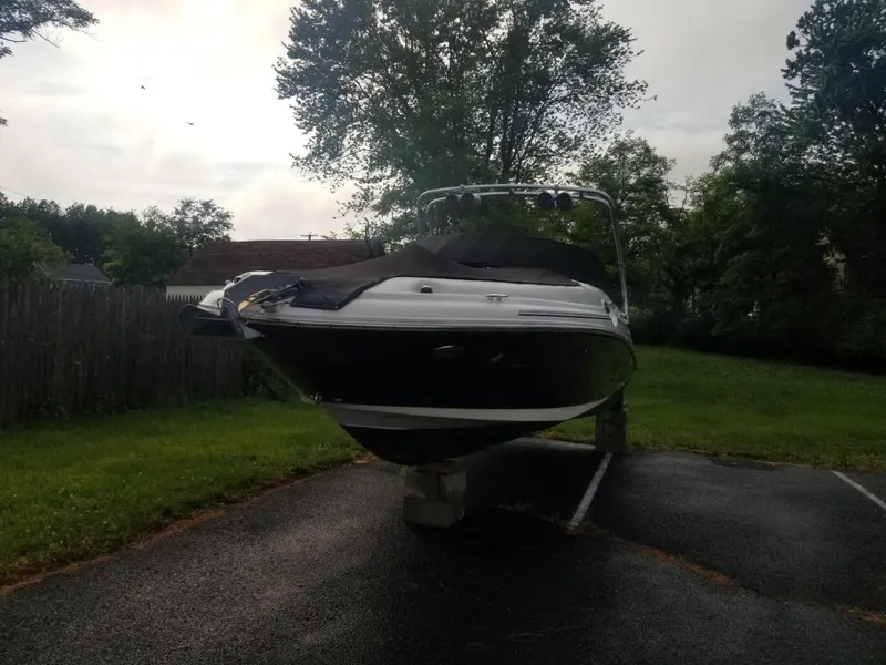 Slide: The Image of 2006 Sea Ray 270 Sundeck boat on blocks in a driveway, surrounded by trees. - 9