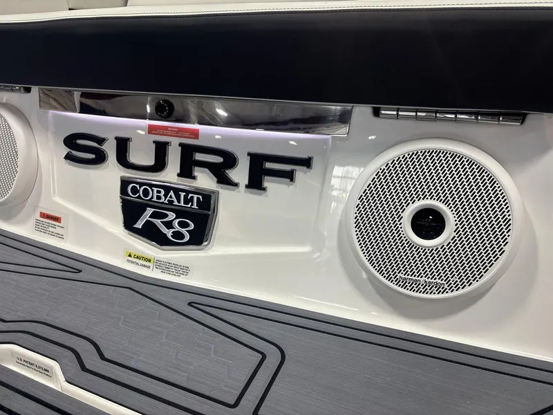 Slide: The Image of 2025 Cobalt R8 Surf boat with speakers and branding details. - 16