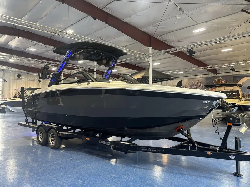 Slide: The Image of 2025 Cobalt R8 Surf boat displayed indoors on a trailer. - 3