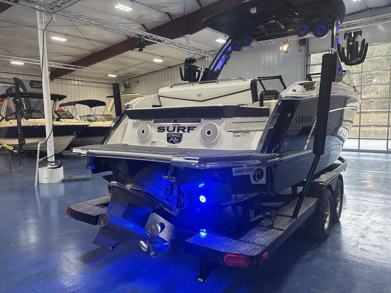 Slide: The Image of 2025 Cobalt R8 Surf boat in showroom, featuring sleek design and advanced surf technology. - 4