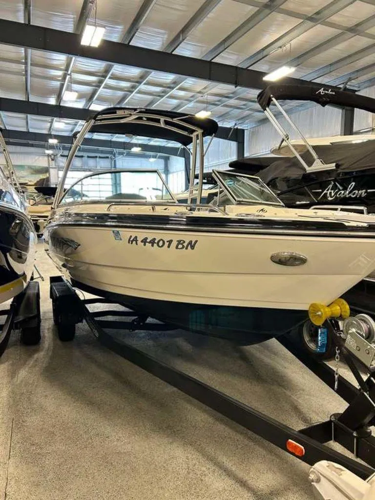 Slide: The Image of 2014 Monterey 224FSX boat on trailer in indoor showroom. - 0