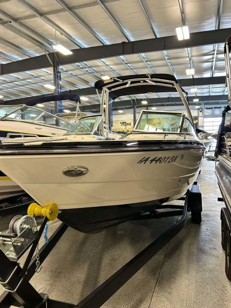 Slide: The Image of 2014 Monterey 224FSX boat on trailer in indoor showroom. - 1