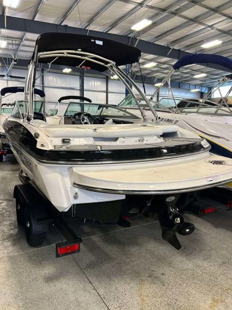 Slide: The Image of 2014 Monterey 224FSX boat in indoor storage, rear view with trailer. - 10