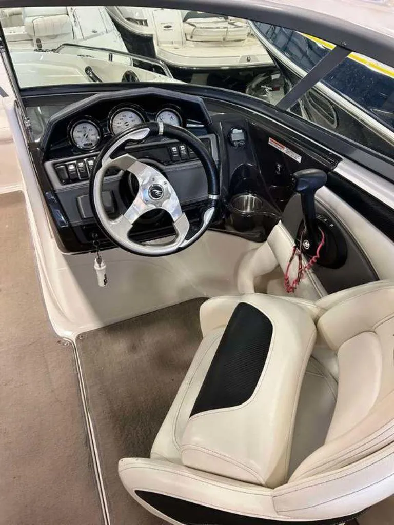 Slide: The Image of 2014 Monterey 224FSX boat cockpit with steering wheel and dashboard controls. - 8