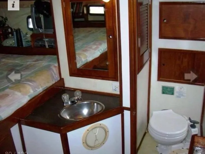 Slide: The Image of Interior of 1980 Wellington 44 Cutter Center Cockpit with sink, mirror, and toilet. - 10
