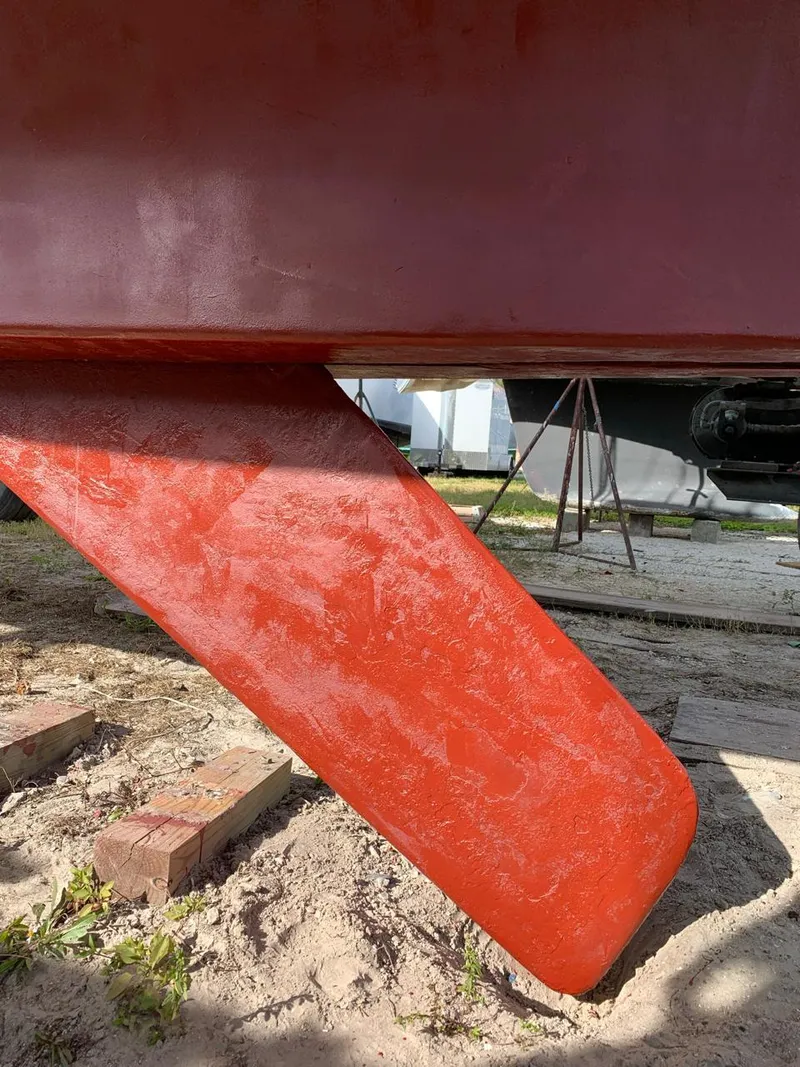 Slide: The Image of Red keel of 1980 Wellington 44 Cutter Center Cockpit sailboat on dry dock. - 12