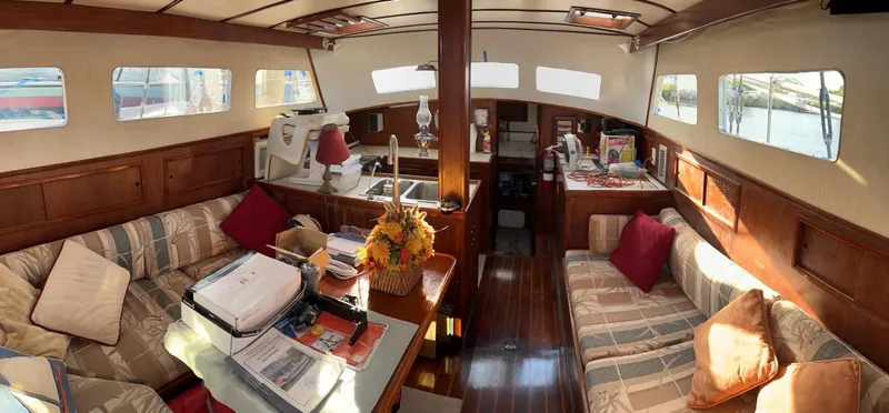 Slide: The Image of Interior of 1980 Wellington 44 Cutter Center Cockpit, featuring cozy seating and wooden finishes. - 4