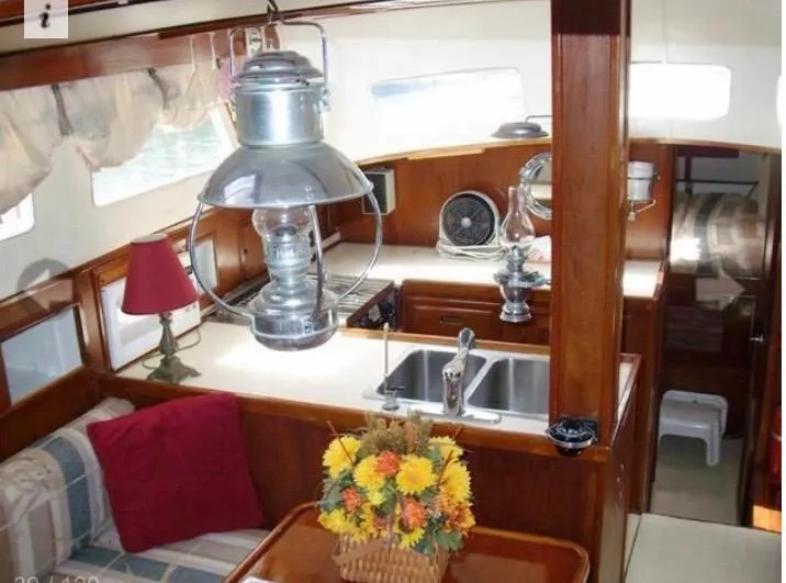 Slide: The Image of Interior of 1980 Wellington 44 Cutter Center Cockpit with cozy seating and nautical decor. - 6