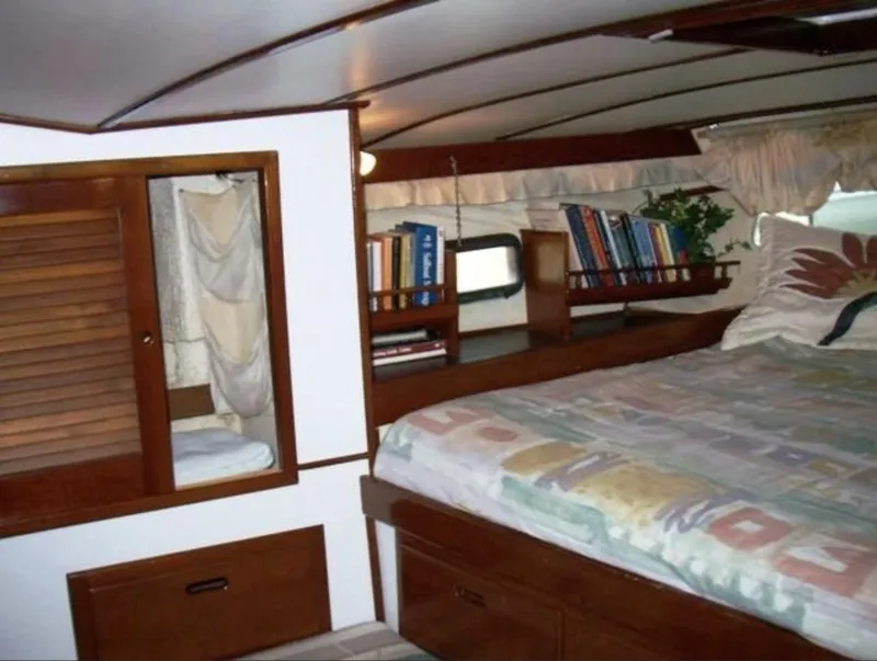 Slide: The Image of Cozy cabin interior of 1980 Wellington 44 Cutter Center Cockpit with bed and bookshelf. - 8