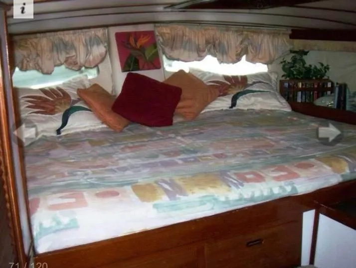 Slide: The Image of Cozy cabin interior of 1980 Wellington 44 Cutter Center Cockpit with colorful bedding and pillows. - 9