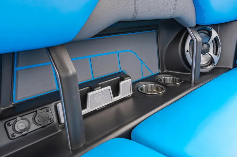 Slide: The Image of 2021 Malibu Wakesetter 25 LSV interior with blue seating, cup holders, and speaker system. - 12