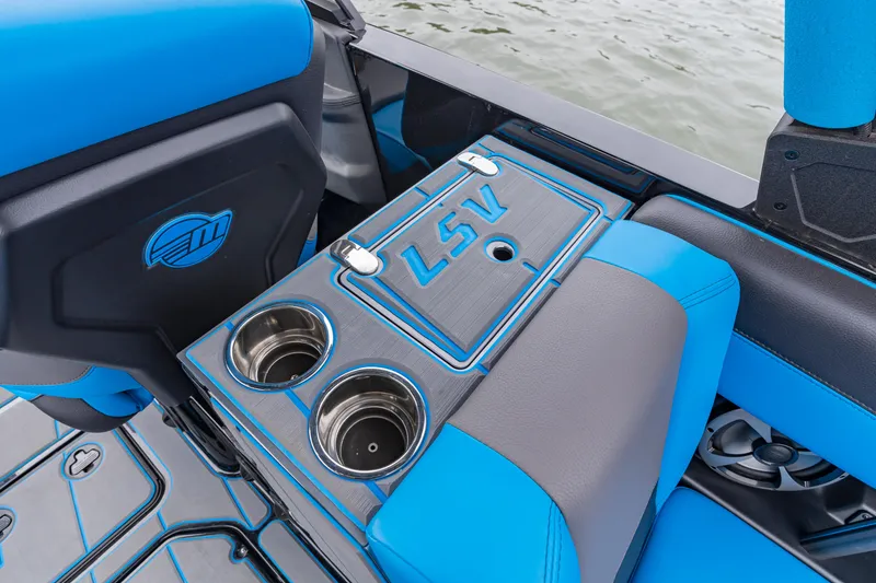 Slide: The Image of 2021 Malibu Wakesetter 25 LSV interior with blue accents and cup holders. - 13