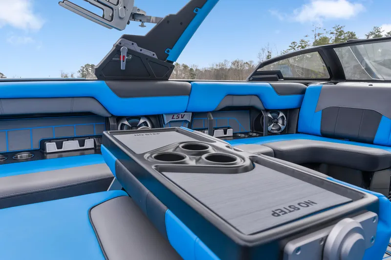 Slide: The Image of 2021 Malibu Wakesetter 25 LSV interior with blue seating and cup holders. - 16