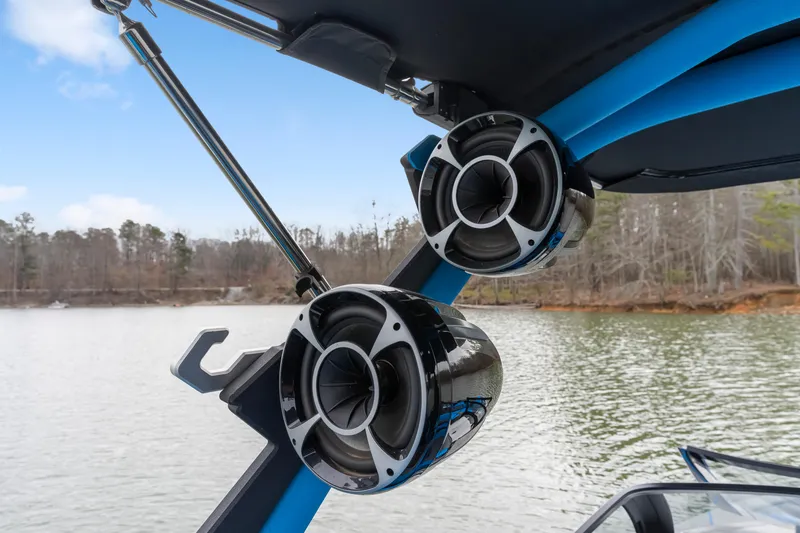 Slide: The Image of 2021 Malibu Wakesetter 25 LSV boat speakers on a lake, showcasing premium audio features. - 17