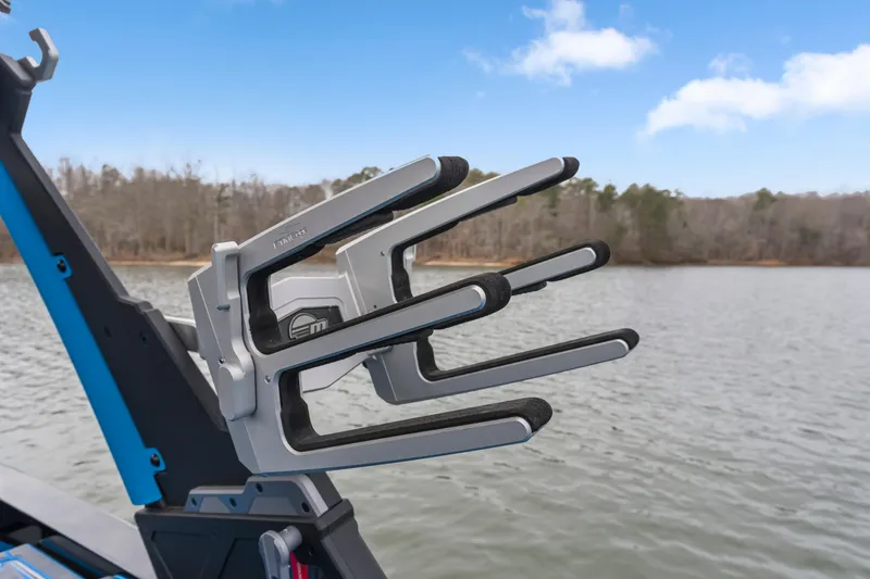 Slide: The Image of Wakeboard rack on 2021 Malibu Wakesetter 25 LSV, lake view in background. - 18