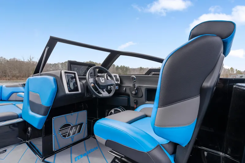 Slide: The Image of 2021 Malibu Wakesetter 25 LSV interior with blue and black seating, modern dashboard. - 19