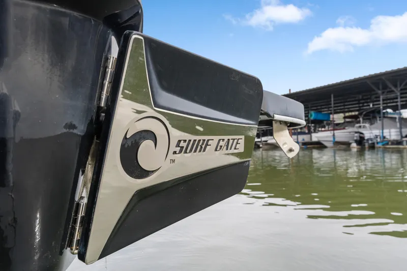 Slide: The Image of 2021 Malibu Wakesetter 25 LSV Surf Gate feature by the water. - 29
