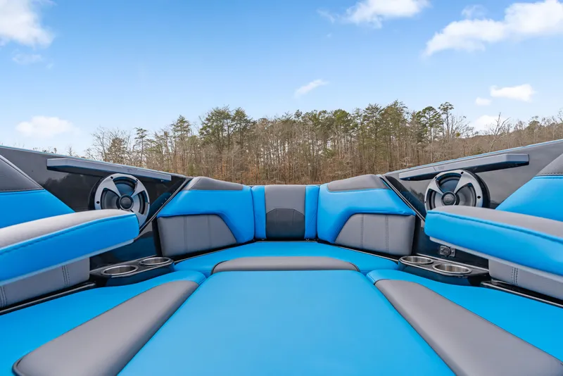 Slide: The Image of 2021 Malibu Wakesetter 25 LSV interior with blue seating and cup holders. - 3